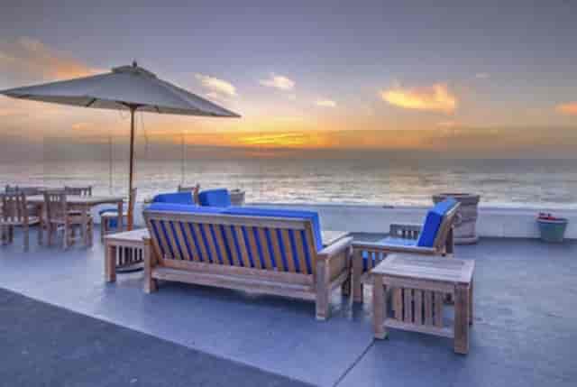 Ocean View Terrace with wooden furniture, ideal for sunset receptions and networking events.