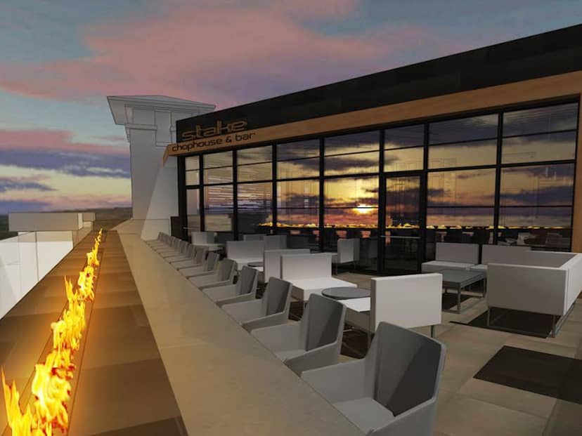 Stylish rooftop restaurant with modern seating and sunset view for events.