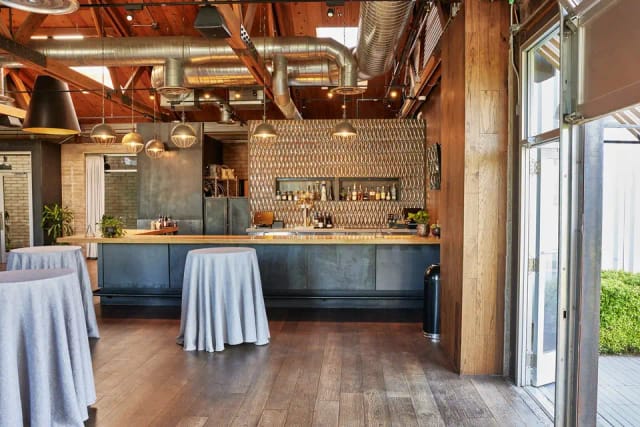 Stylish event space with sleek bar, ideal for networking receptions and cocktail events.