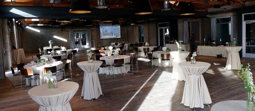 Showcase Room at Culinary Dropout, elegantly draped tables for corporate events and gatherings.