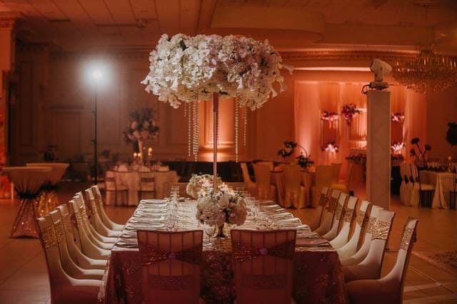 Elegant banquet table with floral centerpiece in upscale event venue for weddings.