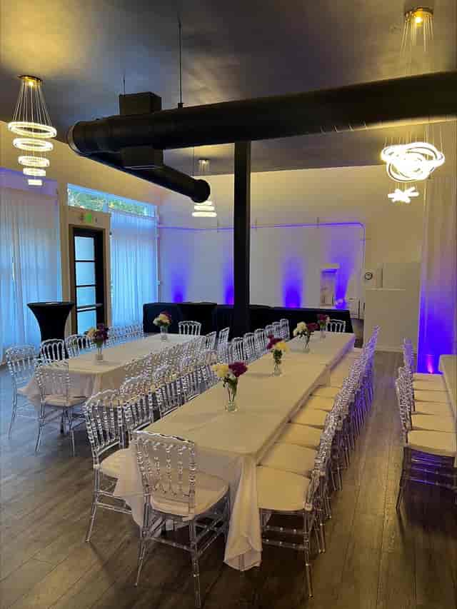 Noir Package at The Prestige Venue: elegant meeting space with floral centerpieces.