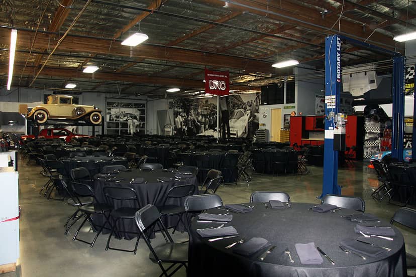Versatile event space with round tables, ideal for corporate gatherings and presentations.