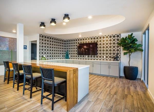 Modern kitchen with large island in San Jose clubhouse for networking events.
