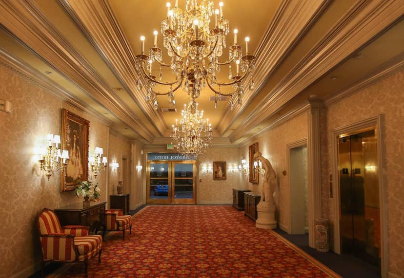 Elegant Bristol Hotel guest room hallway with chandeliers, perfect for upscale events.
