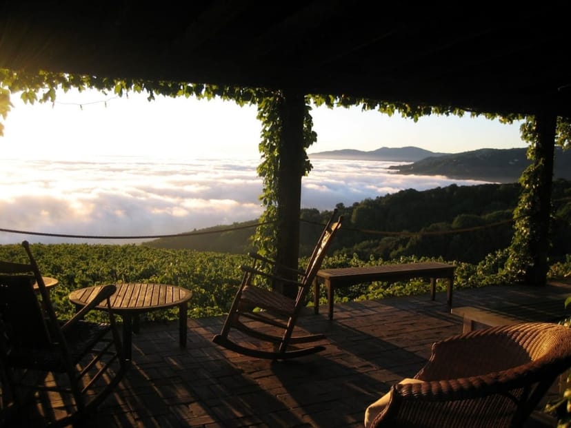Outdoor patio at Domaine Eden with rustic seating, ideal for intimate gatherings and retreats.