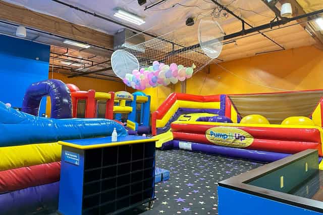 Glow in the Dark Room at Pump It Up San Jose, vibrant inflatable play area for kids' parties.
