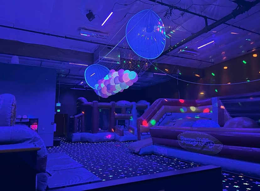 Glow in the Dark Room at Pump It Up San Jose, vibrant inflatable space for kids' parties.