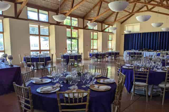 Elegant meeting room with purple linens and gold chairs at Green Mountain Retreat.
