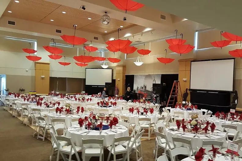Grand Ballroom in Palo Alto Event Center with red umbrellas, ideal for formal events and presentations.