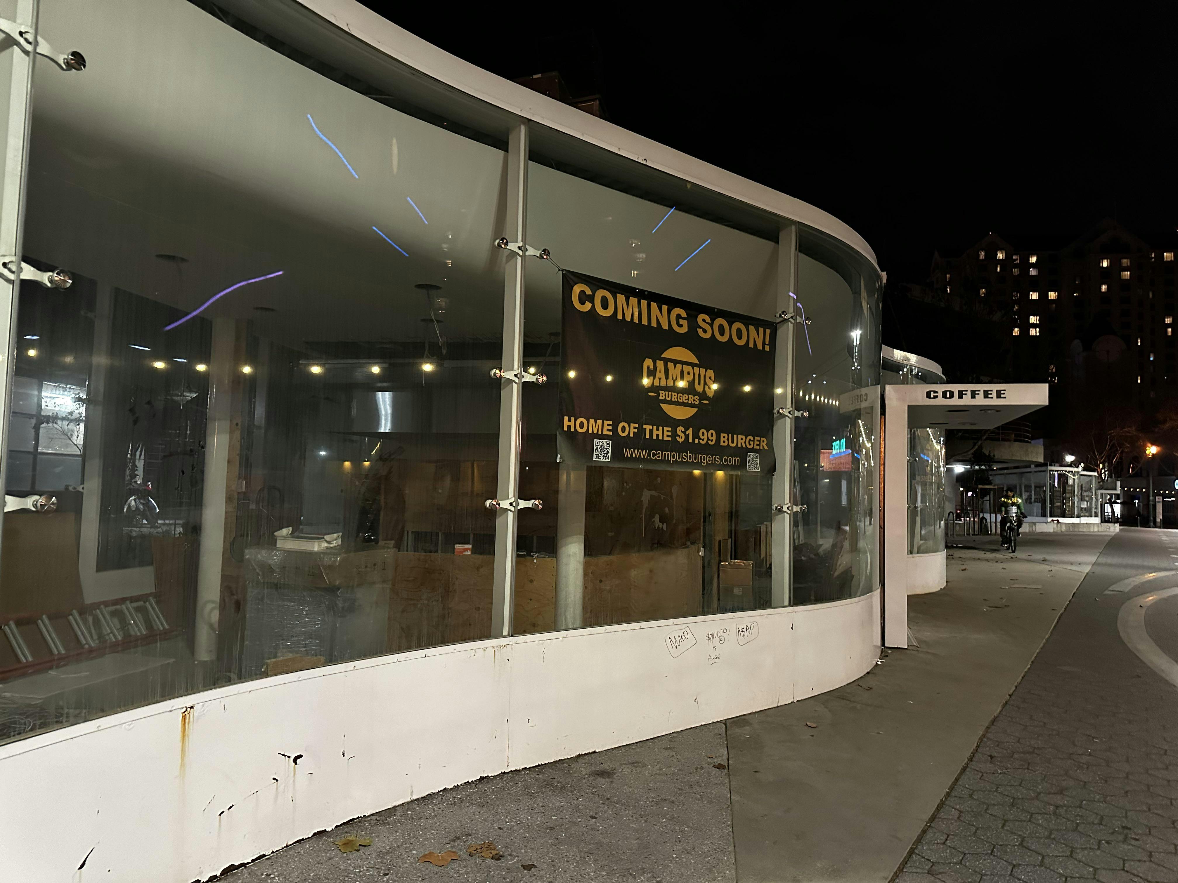 Modern glass-fronted Mama Kin patio with "Coming Soon" sign for events and meetups.