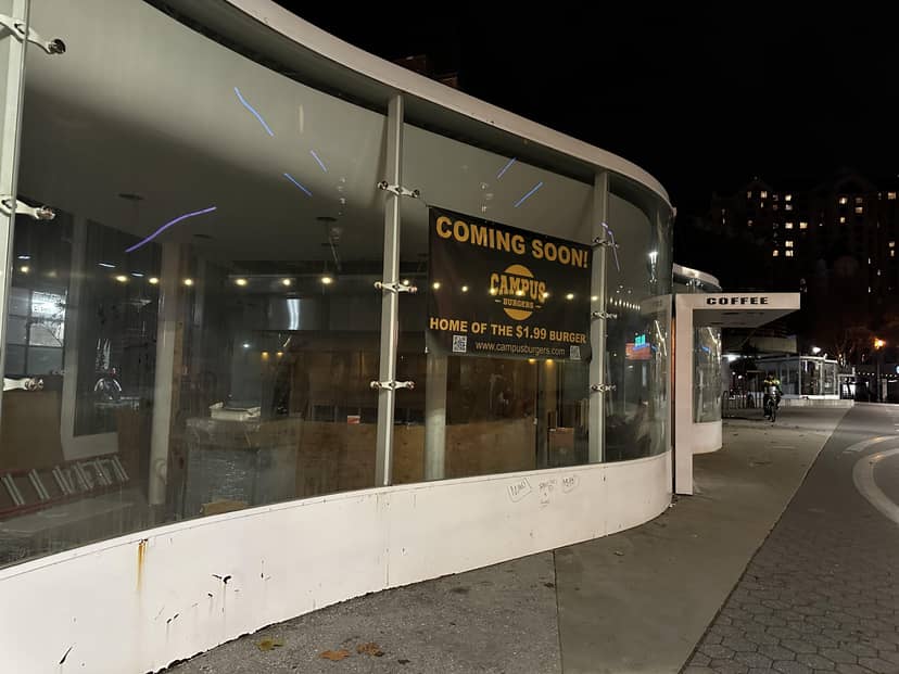 Modern glass-fronted Mama Kin patio with "Coming Soon" sign for events and meetups.