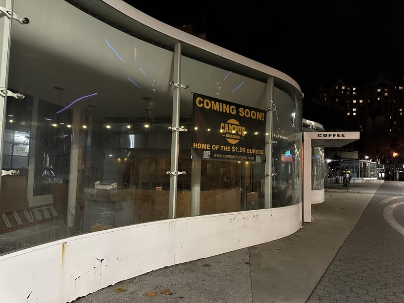 Modern glass-fronted Mama Kin patio with "Coming Soon" sign for events and meetups.