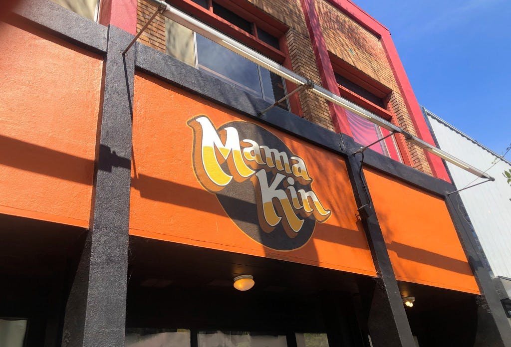 Vibrant Mama Kin restaurant exterior, perfect for casual meetings and events.