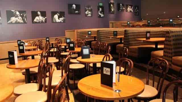 Cozy Wai-Wai Room at Yoshi's with wooden tables, perfect for intimate gatherings and meetings.