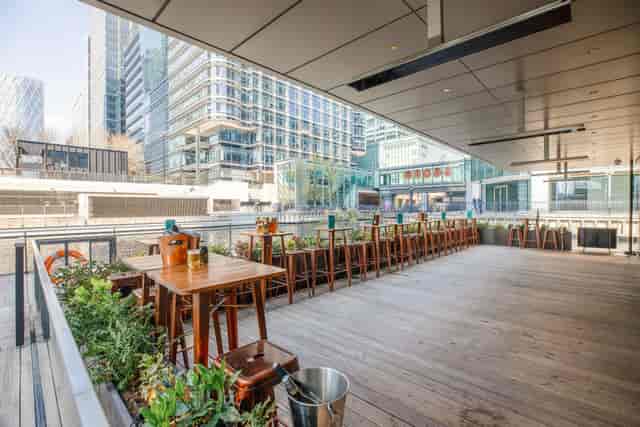 Oasis Bar terrace for corporate networking and business events with high-top seating.