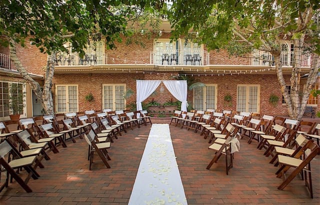 Outdoor courtyard at Horton Grand Hotel, ideal for weddings with elegant drapery and floral accents.