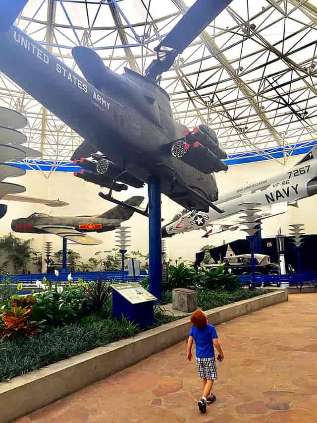 Fire pit in Hangar 858 with vintage aircraft, perfect for corporate events and gatherings.