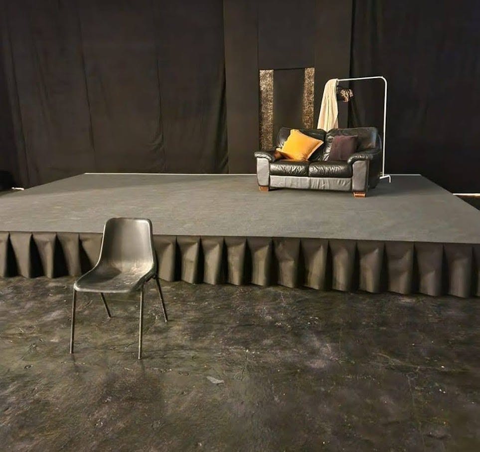 Birmingham Black Box Theatre stage with leather couch, ideal for workshops and interviews.