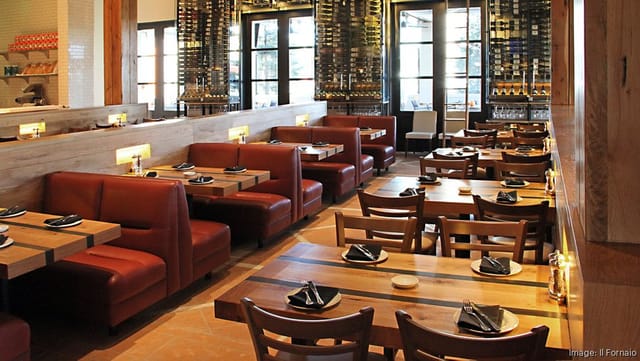 Modern restaurant interior with leather booths, ideal for networking events and casual dining.