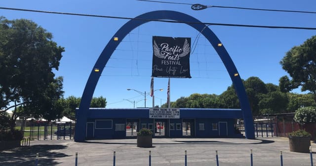 Vibrant Santa Clara County Fairgrounds arena with blue archway for outdoor festivals.