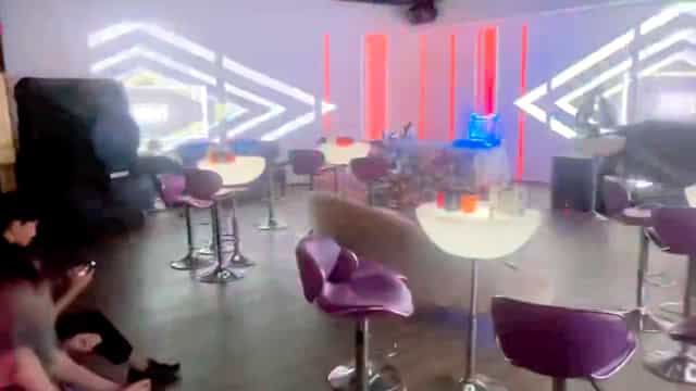 Private party room at Homestead Bowl with modern furniture and vibrant lighting.