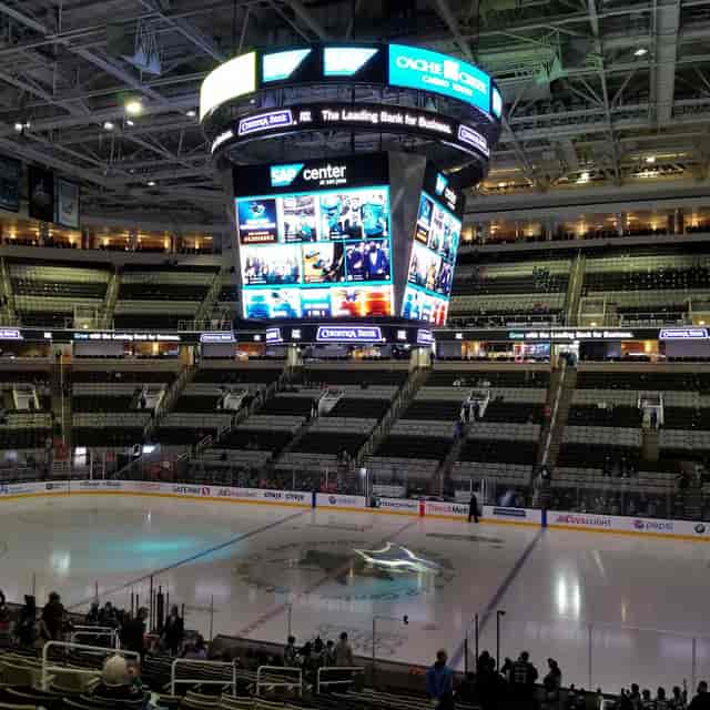 Versatile event space at SAP Center with central video board for sports and corporate events.