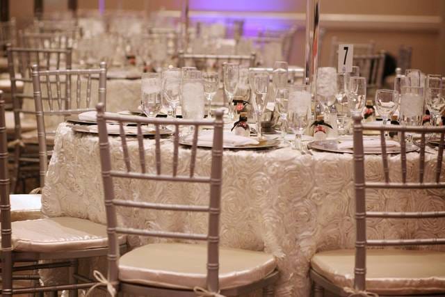 Elegant banquet table with silver chiavari chairs for weddings and upscale events.