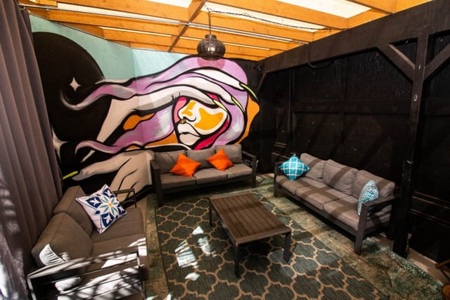 Stylish outdoor lounge with vibrant mural for networking events at 1835 Studios.