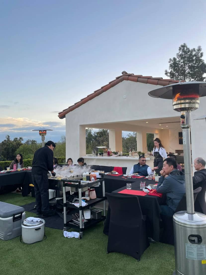 Outdoor dining setup at Hibachi Kings for a corporate event with barbecue station.