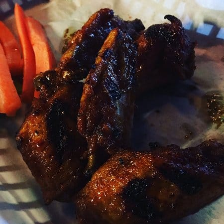 Grilled ribs with carrot sticks at JT's Bar & Grill, perfect for events and catering.