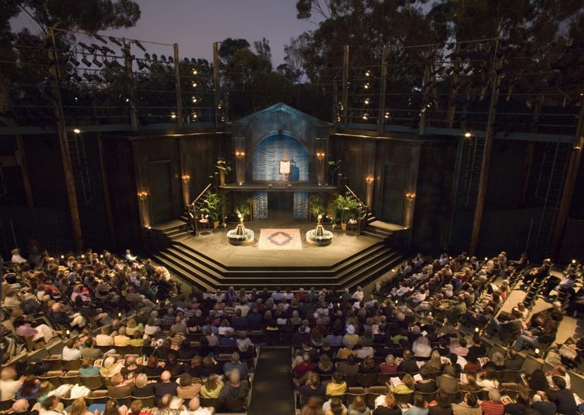 North Park Playwright Festival at outdoor amphitheater with engaged audience and scenic backdrop.