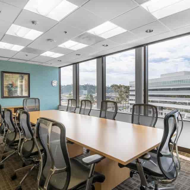 Modern conference room with large windows at Hardihood Cowork Space for corporate meetings.