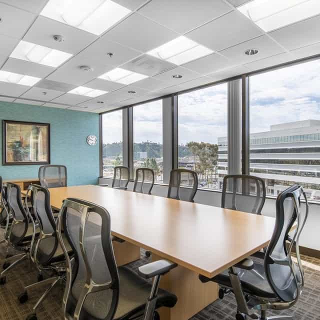 Modern conference room with large windows at Hardihood Cowork Space for corporate meetings.