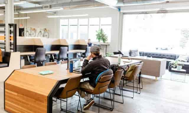 Modern private office with wooden table, ideal for coworking and meetings.