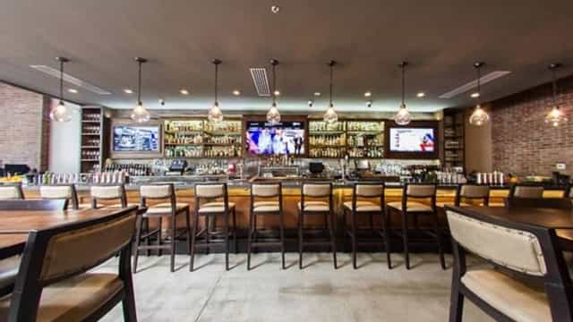 Private room at Willard Hicks Grill with modern bar, ideal for networking events and gatherings.