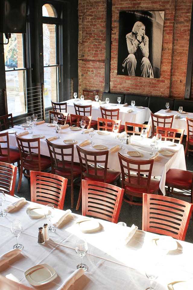 Elegant dining setup with white tablecloths at The Loft Bar and Bistro for events.