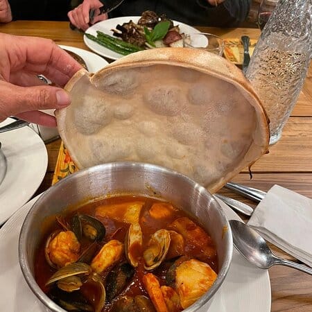 Seafood stew with flatbread at Campo Di Bocce, perfect for events and culinary experiences.