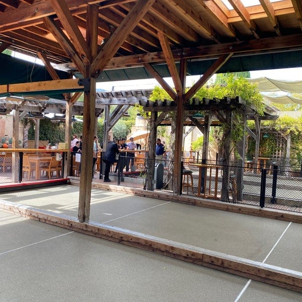 Outdoor patio with bocce ball court, ideal for casual gatherings and networking events.