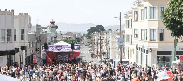 Union Street Festival with vibrant crowd, stage for live performances, outdoor event.