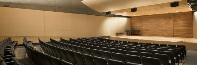 Tateuchi Hall auditorium with tiered seating, ideal for concerts and conferences.