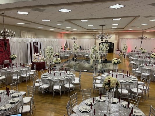 Elegant event space in Newark Pavilion with round tables and floral centerpieces.