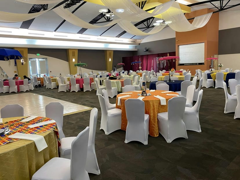 Vibrant event space with round tables, ideal for networking and social gatherings.