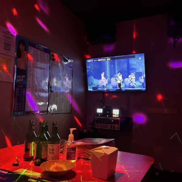 Vibrant karaoke room with colorful lighting for team-building events and social gatherings.