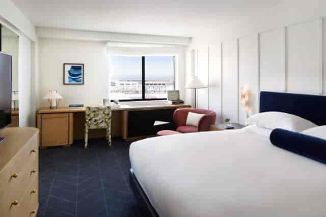 Modern hotel room at Kimpton Alton, featuring a spacious desk for business travelers.