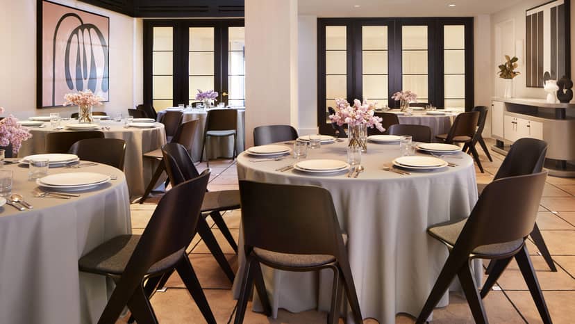 Elegant event space at Kimpton Alton Hotel with round tables for corporate meetings.
