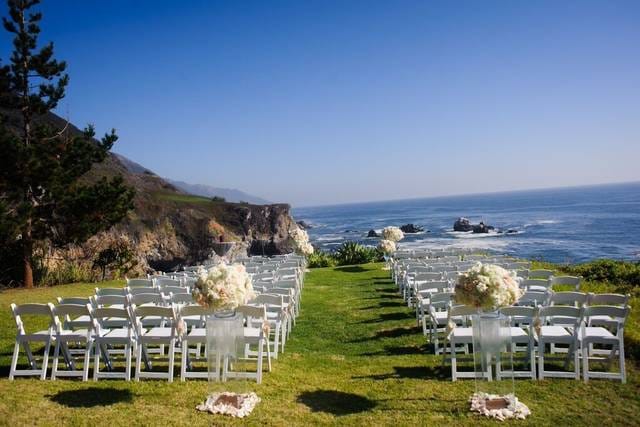 Outdoor wedding setup with white chairs and ocean view at Amazáe Events.