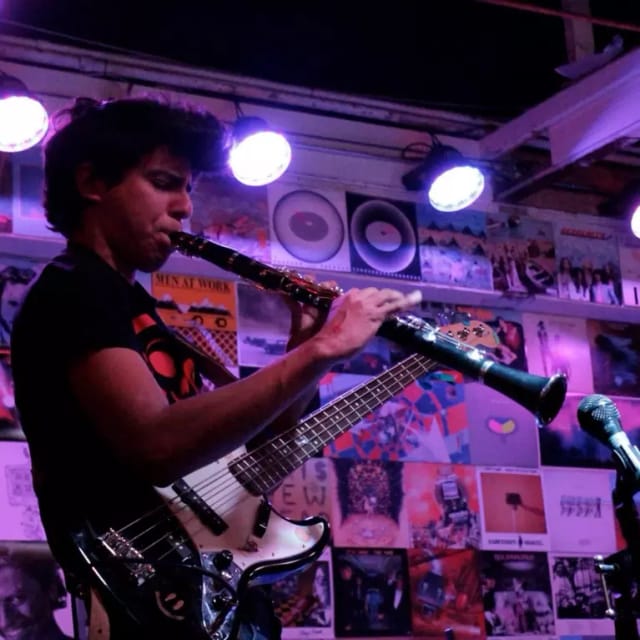 Musician playing clarinet at The Art Boutiki Music Hall, vibrant live entertainment event.