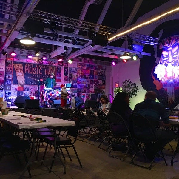 Vibrant event space with colorful stage for artistic gatherings and community events.