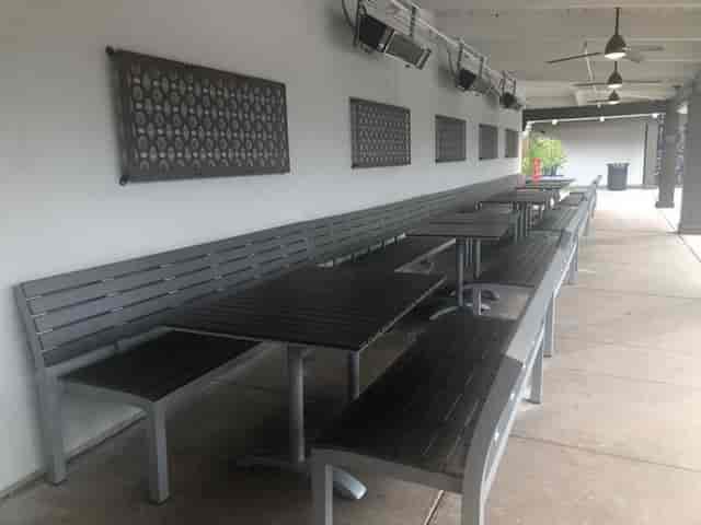 Semi-private outdoor dining area with modern tables for casual gatherings in San Jose.